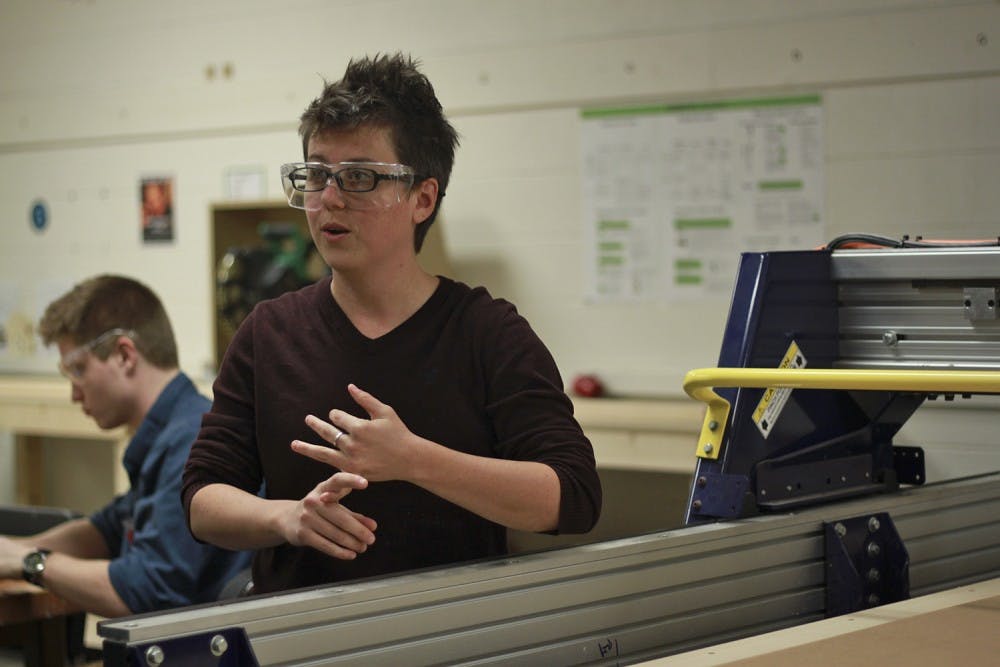Michelle Garst, program manager of BeAM, explains the ShopBot, a computer-controlled router. The ShopBot can cut and engrave wood and plexiglass with extreme precision, used to make things like furniture and signs. Once properly trained, students can use the ShopBot for projects. 