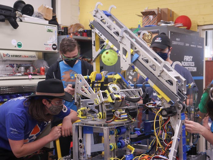 Members of Team 587, The Hedgehogs, work on a robot named Freefall on Thursday, April 14, 2022 for this year's worldwide robotics competition taking place in Dallas, Texas.