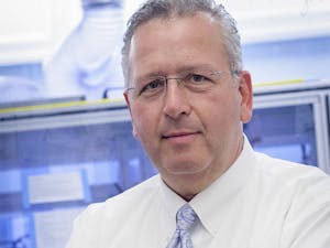 Professor Joseph DeSimone pictured in front of the roll-to-roll particle-fabrication unit housed at UNC-Chapel Hill's Caudill Labs. Roll-to-roll fabrication technology is used in the manufacture of vaccines and medicines.
