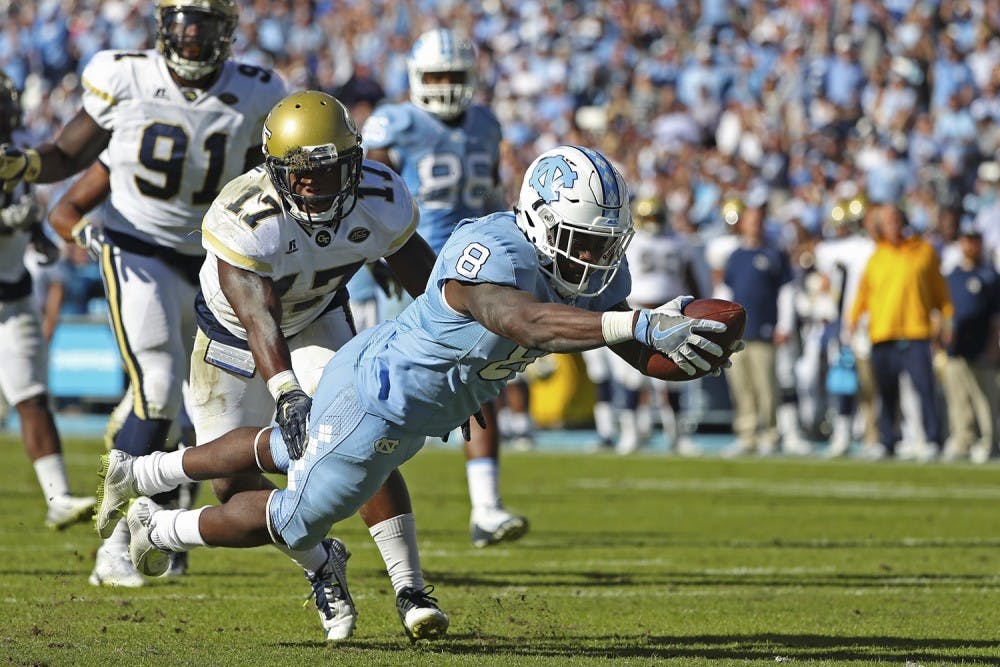 <p>Former North Carolina running back T.J. Logan (8) dives into the end zone against Georgia Tech in 2016.</p>