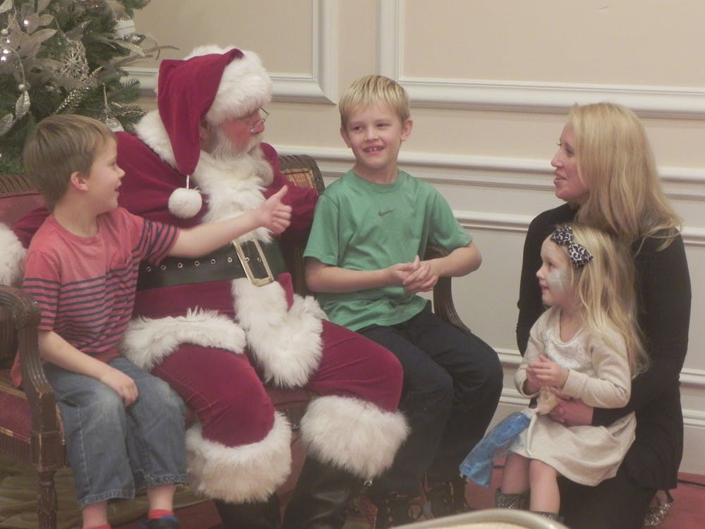 Jackson (left), 6, and Lucas Stansell (right), 9, meet with Lee Humphries, a professional Santa.