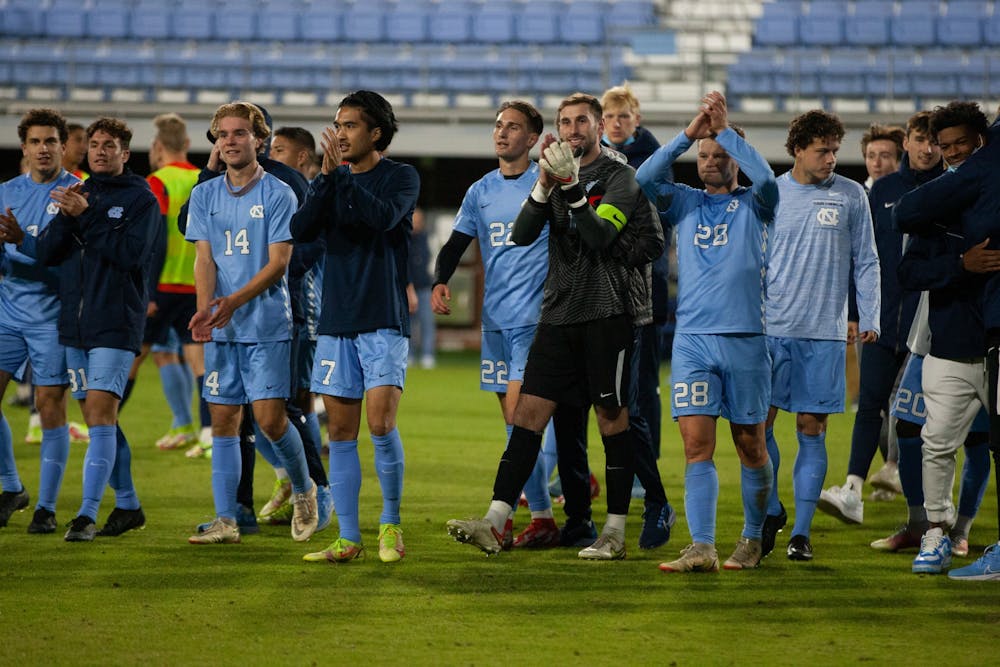 UNC men's soccer players celebrate their win at the first round of the ACC men's soccer tournament against Syracuse on Nov. 3 at Dorrance field. UNC won 1-0 in the second overtime.
