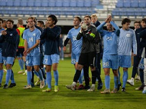 UNC men's soccer players celebrate their win at the first round of the ACC men's soccer tournament against Syracuse on Nov. 3 at Dorrance field. UNC won 1-0 in the second overtime.