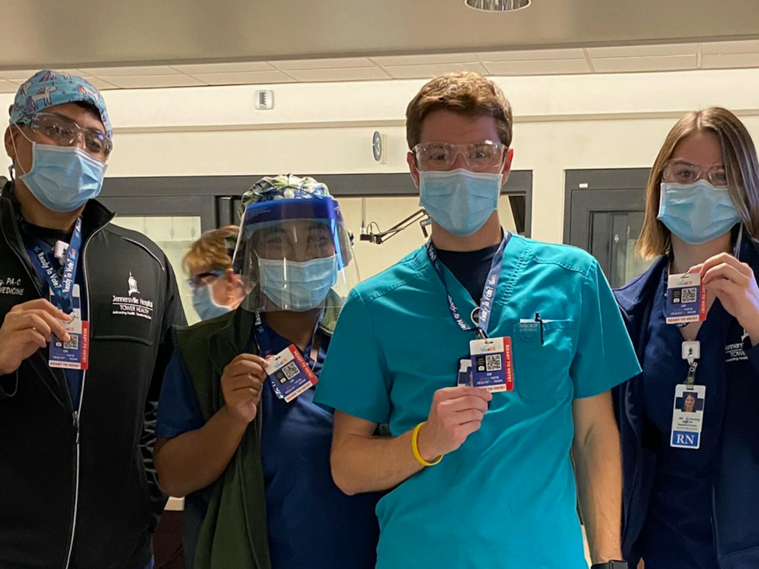 Hospital workers pose with their kits and badges. Photo courtesy of Noam Brenner.
