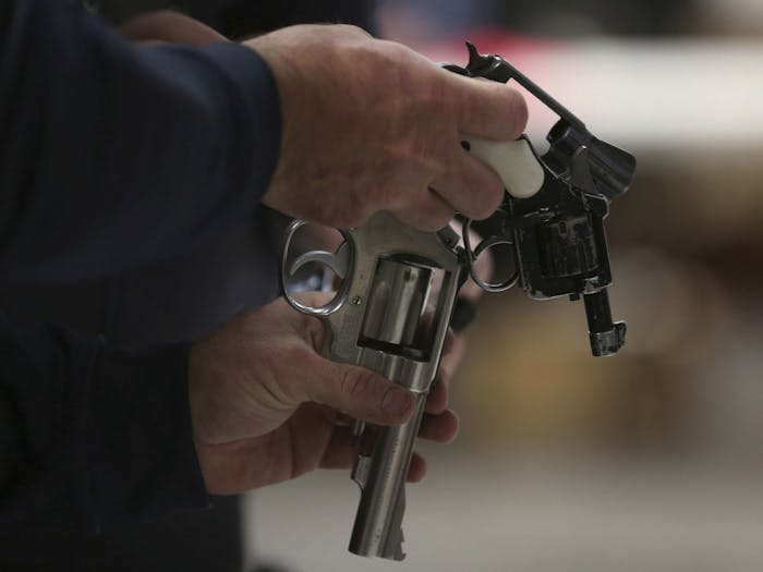 A Chicago police officer inspects guns during a buyback program in 2016. Photo courtesy of TNS.