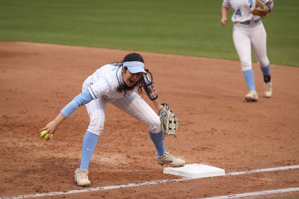 First-baseman Kiersten Licea (1) narrowly snags the ball as it is hit to first base during a home game against UNCW. UNC won 2-0 on Tuesday, March 15, 2022.