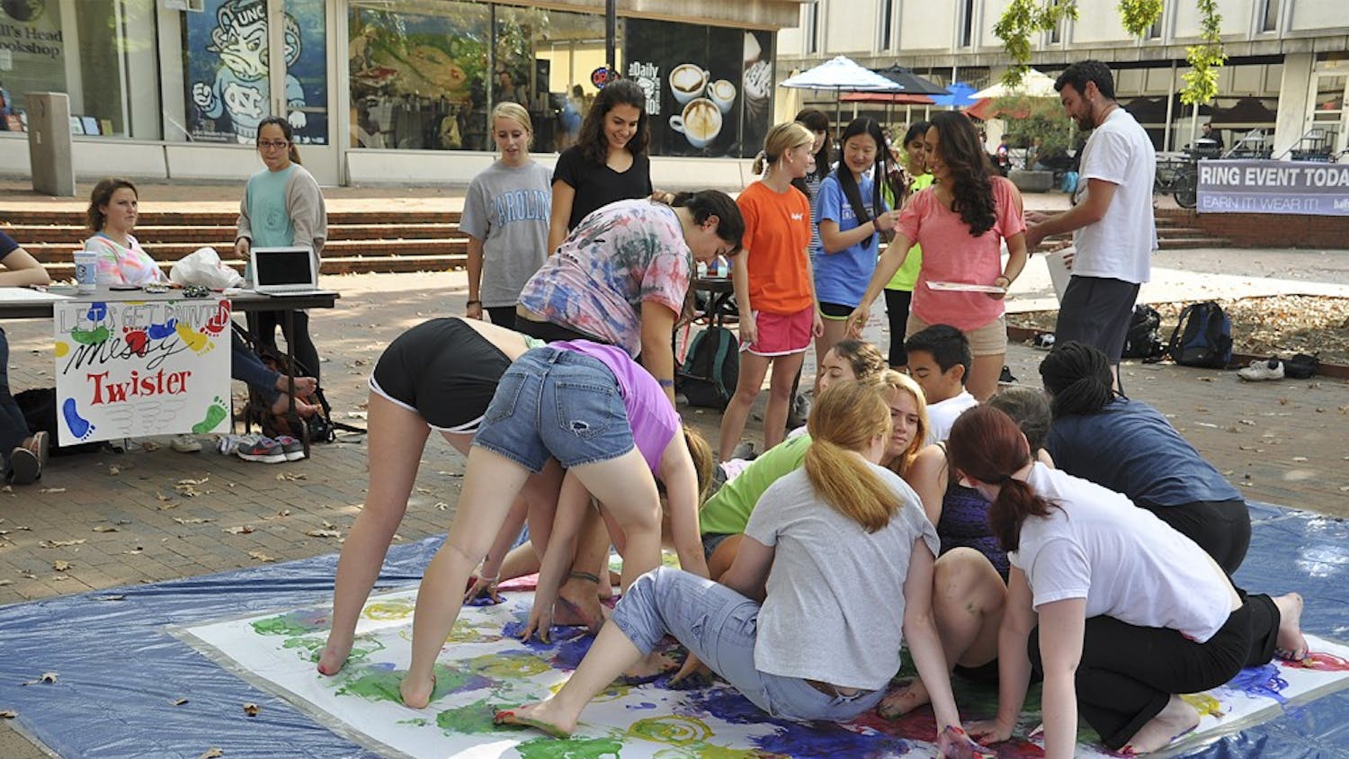 ArtHeels, an organization of students that participates in art-therapy for mental illnesses, held a game of "Messy Twister" with colorful paint on Wednesday afternoon in the pit for students to de-stress during midterms. 