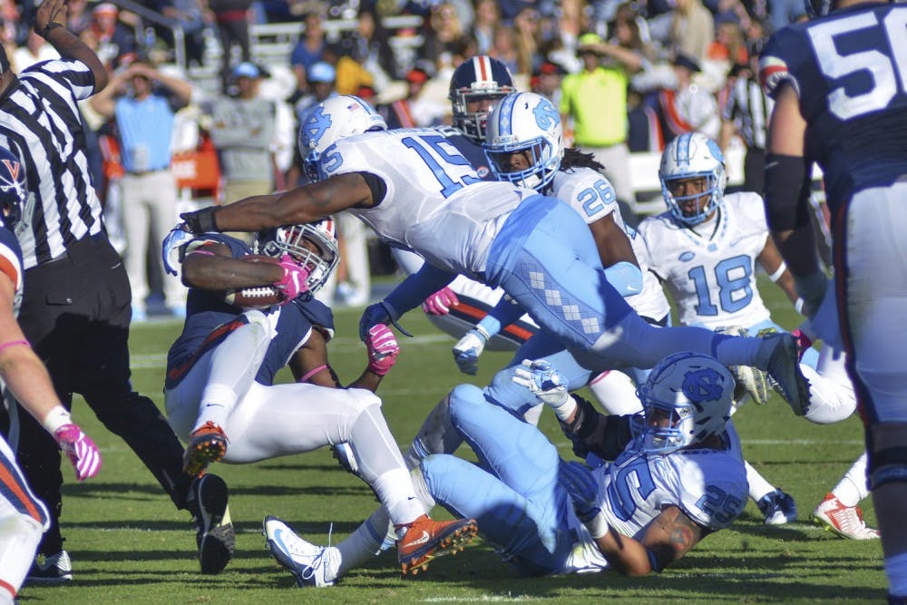 Donnie Miles (15) tackles a Virginia player. UNC defeated UVA 35-14 on Saturday, October 23.