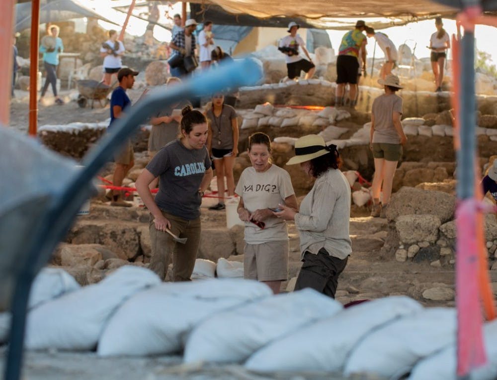 (From left to right) Jocelyn Burney, Magness and Shua Kisilevitz discuss strategy at the excavation site in Huqoq, Israel. (Photo by Will Melfi)
