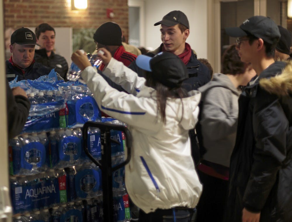 Carolina Dining Service employees hand out water to students during the water crisis.&nbsp;