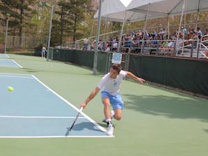 Senior Robert Kelly hits a backhand against Georgia Tech on April 14 at the Cone-Kenfield Tennis Center.