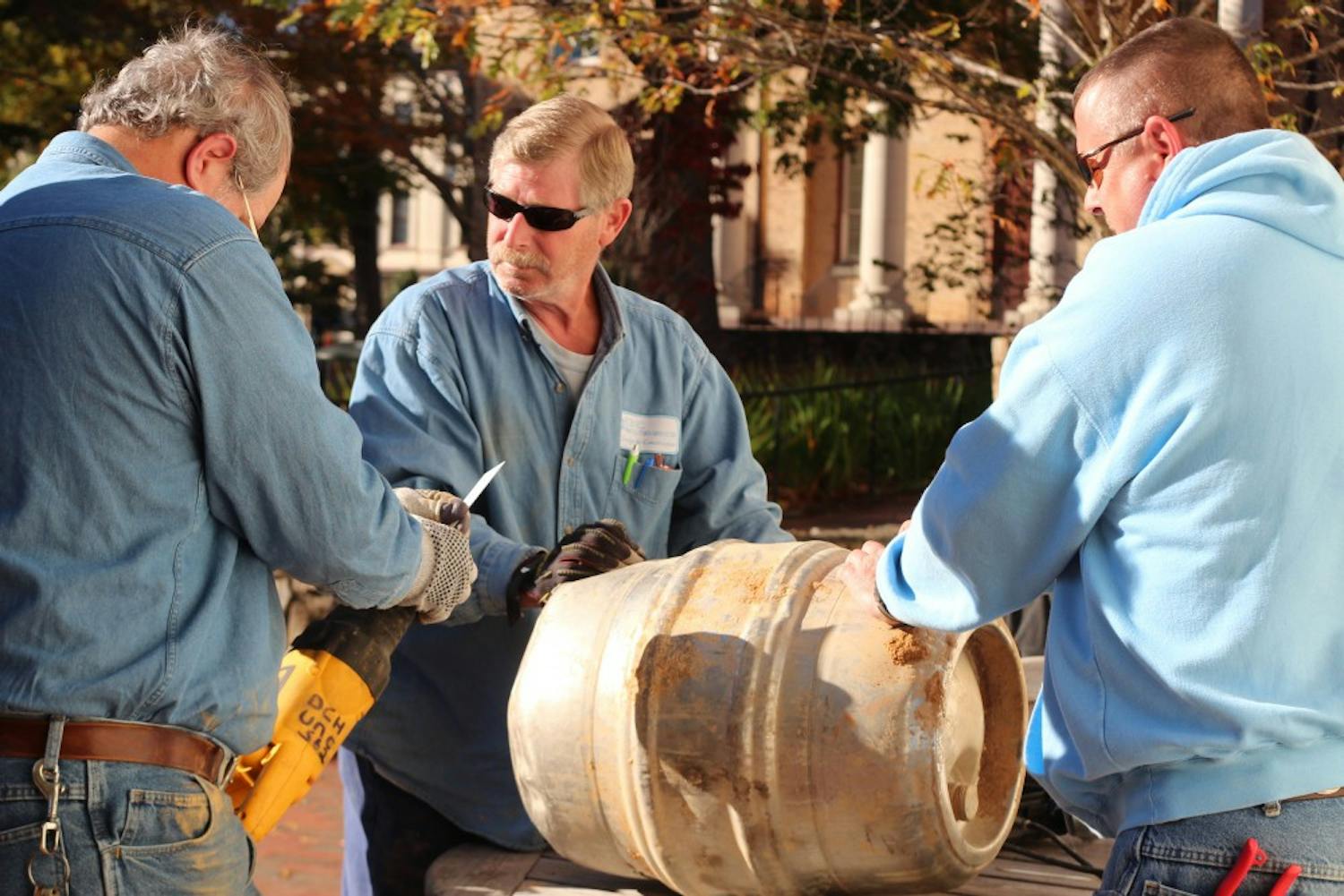 The graduating class of 1988 returned to campus to recover the time capsule they buried a quarter of a century earlier. The time capsule, a stainless steel keg donated by a then local bar, proved to be a challenge for the grounds workers that had to both dig it up and cut through it on Friday at 1 p.m. The keg was buried under a plaque on Polk Place between the flagpole and  South Building. The alumnae will be celebrating their 25th reunion during Homecoming weekend and look forward to exploring the capsule's artifacts in Wilson Library this week.