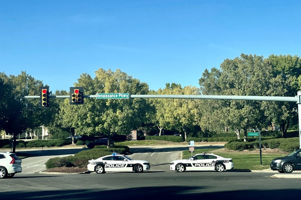 Police cars line Renaissance Parkway, one of the entrance streets of Southpoint Mall in Durham, on Oct. 24 after hearing reports of an incident involving a firearm. 