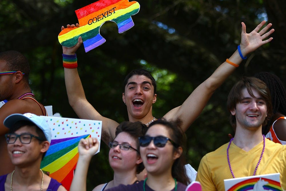 Kyle Kufert, a junior biology major from Charlotte, rides on the UNC LGBTQ Center float at the NC Pride Festival and Parade in Durham on Sept. 27, 2014.