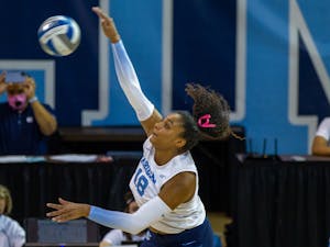 Graduate student outside hitter Nia Robinson (18) hits the ball at the volleyball game against Duke on Oct. 22 at Carmichael Arena. UNC won 3-0.