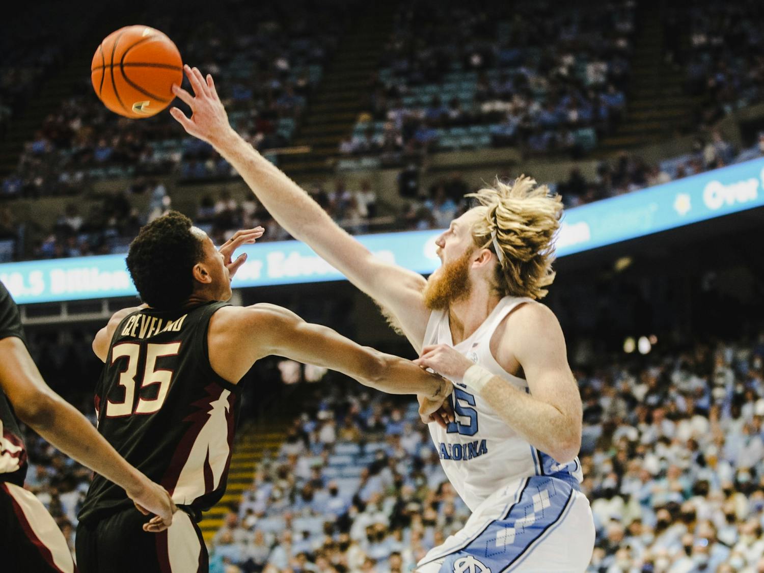 Graduate student forward Brady Manek (45) fights for the ball during the home men's basketball game against Florida State on Saturday, Feb. 12, 2022. The Tar Heels won 94-74 in the Dean Dome.