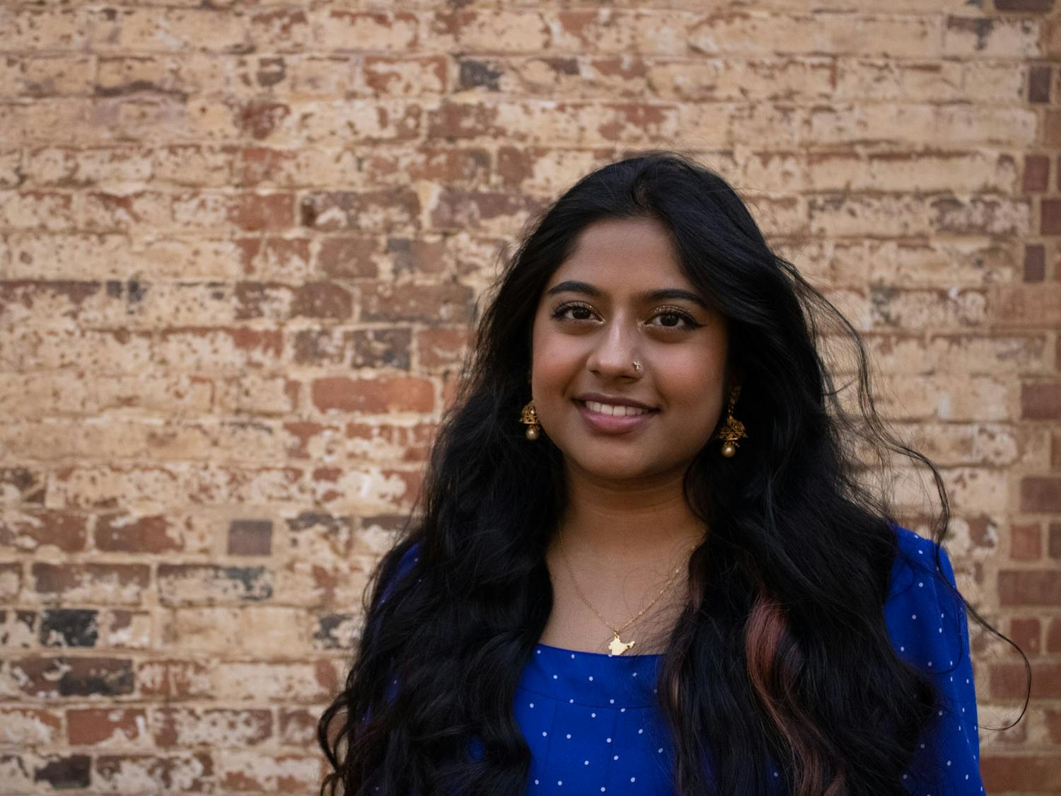 Junior Nasiha Haja Rizwan, president of Tamil Student Organization, poses for a portrait outside of Gerrard Hall on Tuesday, April 4, 2022. Rizwan founded TSO while students were at home during the COVID-19 pandemic. The student organization is now starting in-person programming.