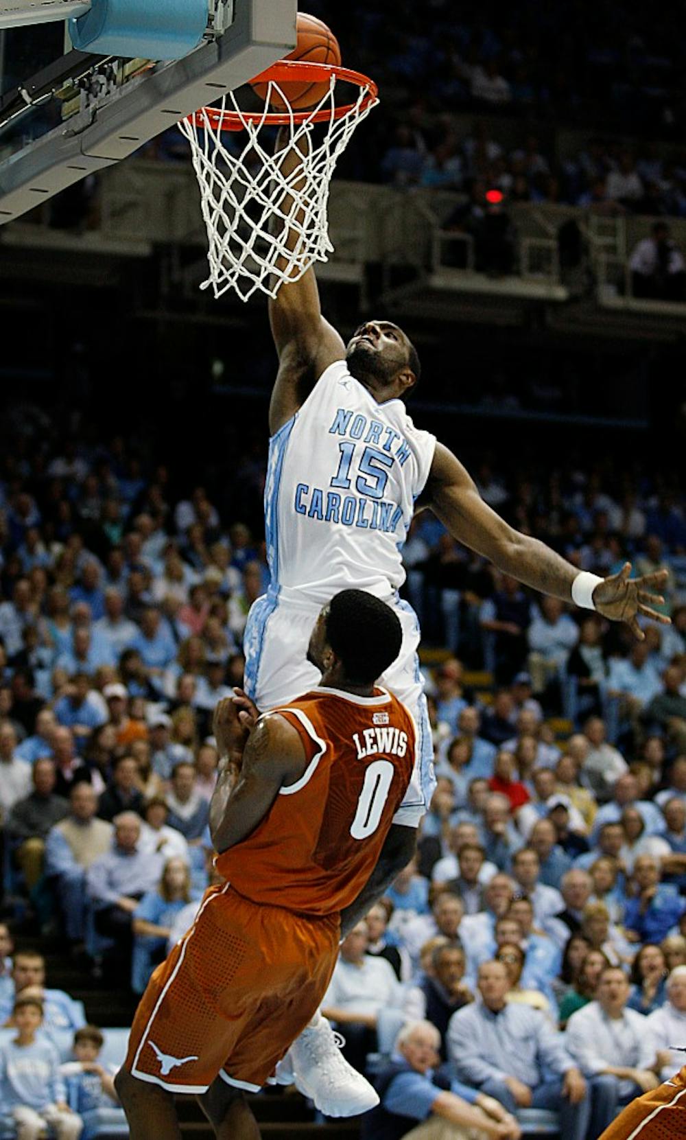 UNC guard P.J. Hairston dunks the ball over Texas guard Julien Lewis during the game Wednesday at the Dean E. Smith Center. Hairston had 5 points in the Tar Heels 82-63 win over Texas.