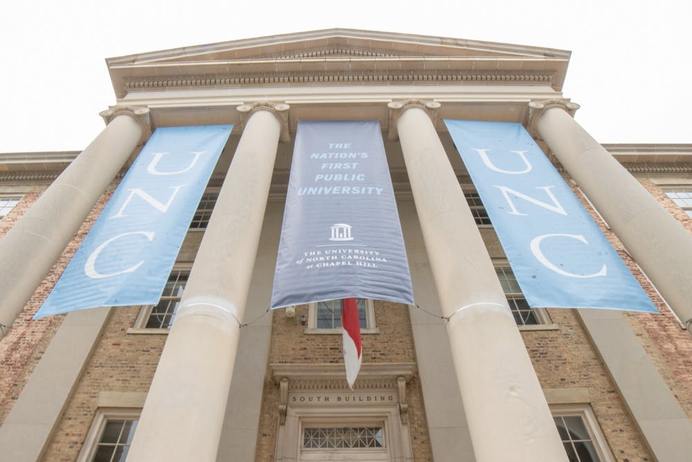 Banners fly on UNC's South Building on Oct. 11, 2021.