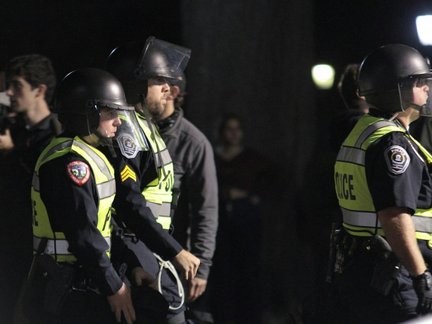 Police officers put on riot gear during the demonstration against the decision to place Silent Sam in a new historic building on campus on Monday, Dec. 3, 2018.