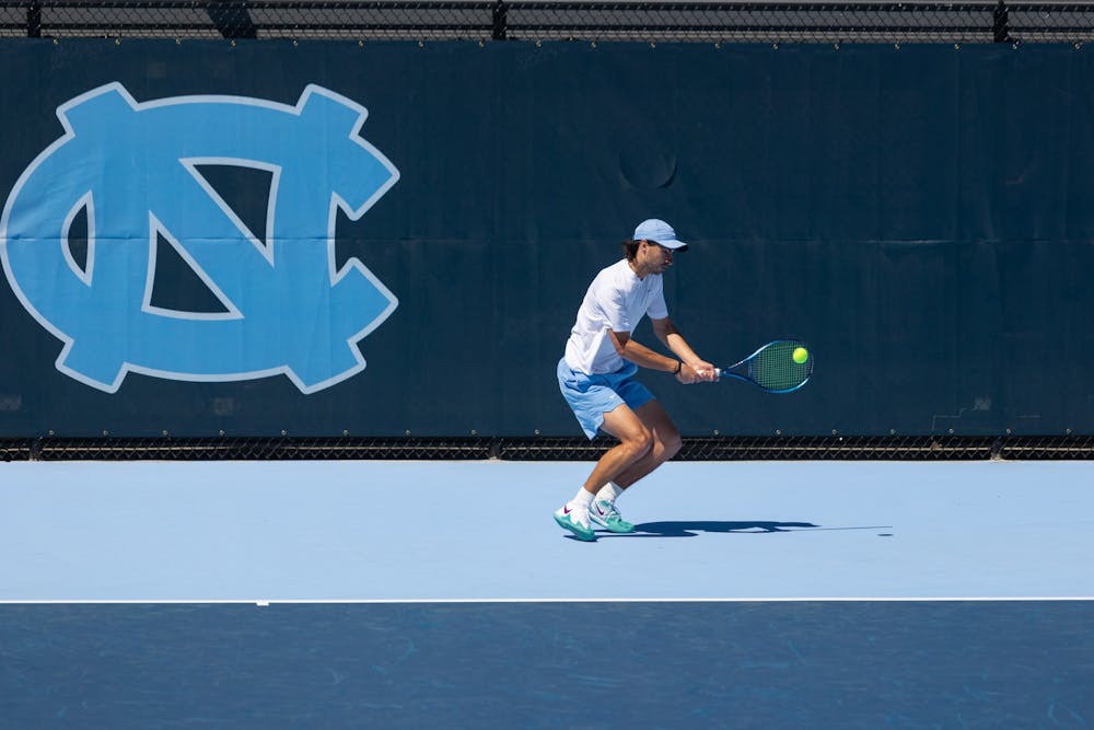 UNC graduate student Karl Poling returns a volley during the mens’ tennis match against Wake Forrest at the newly opened Cone-Kenfield Tennis Center in Chapel Hill on Sunday, April 2, 2023. UNC beat Wake Forest 4-3.
