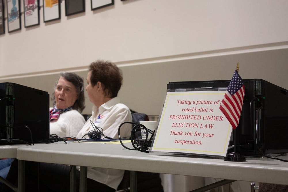 Country Club precinct's Chief Judge Carol Hazard and Democratic representative Barbara Wendell work the check-in table at the Paul Green Theatre on Tuesday, Nov. 5, 2019.