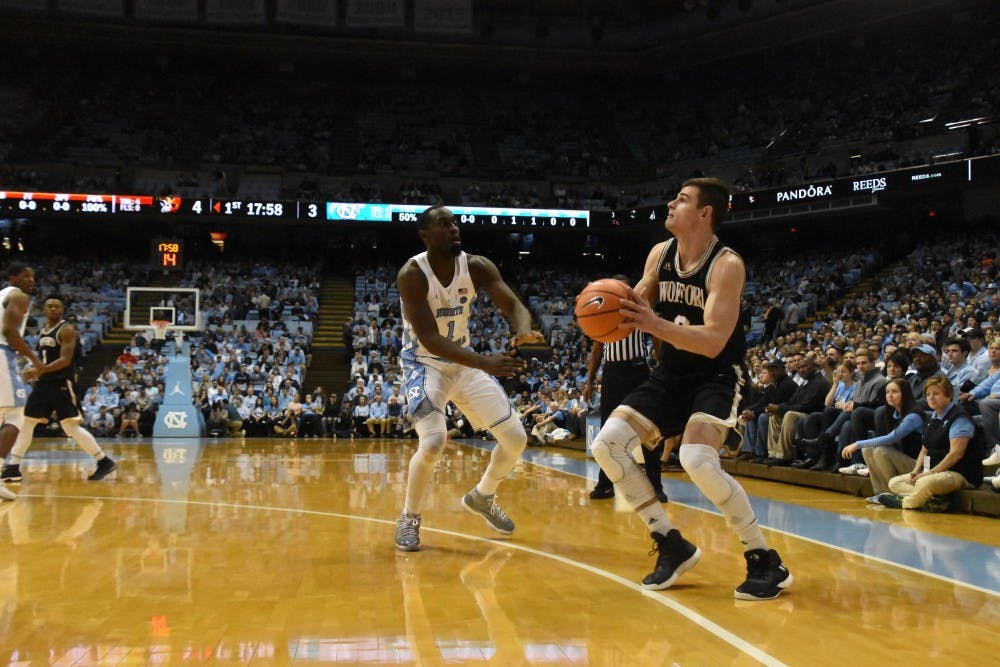 <p>Wofford guard Fletcher Magee (3) prepares to shoot as North Carolina wing Theo Pinson (1) closes in on him during a Dec. 20 game in the Smith Center.</p>