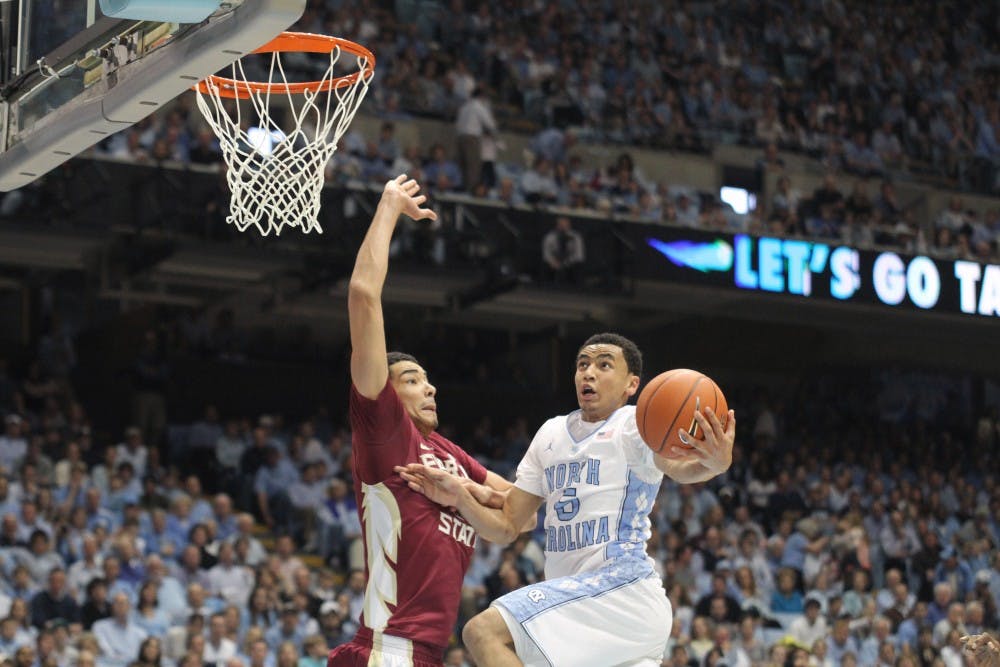 	<p>Marcus Paige drives to the basket and flips up a shot. Paige had 6 points and tallied 9 assists for the day.</p>