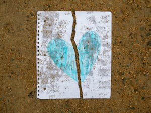 Mediating conflicts between platonic friends can present challenges unlike those faced by romantic partners.
A heart drawn on notebook paper that has been ripped in half is on the ground on March 2, 2023.