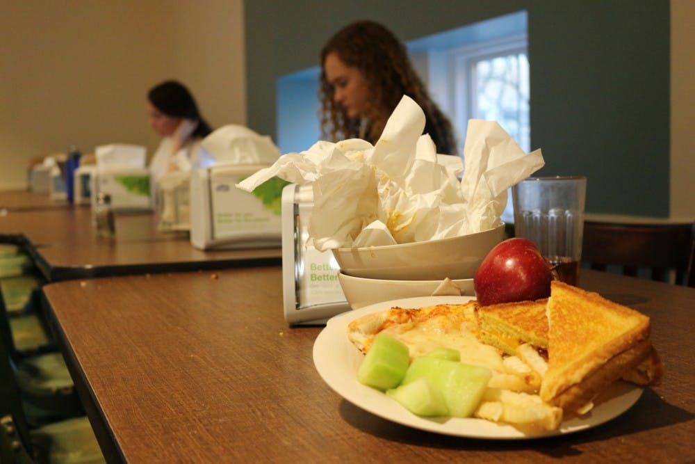 Leftover food and bowls left by a student in Lenoir Dining Hall with first years Deanna Upchurch and Emma Berry, who are studying for their upcoming finals.