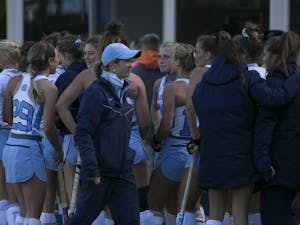 Head coach Karen Shelton celebrates with the UNC field hockey team after a 5-2 win against Michigan during the second round of the NCAA Tournament Sunday, Nov. 11, 2018 in Karen Shelton Stadium. 