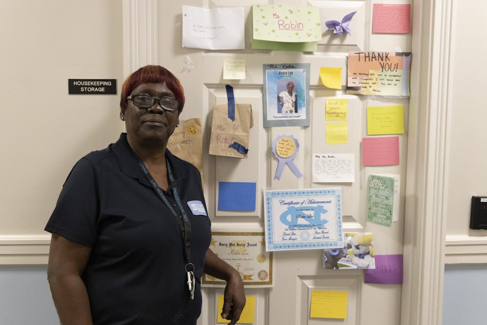 Robin Lee, a beloved housekeeper in Kenan Residence Hall, poses for a portrait on Monday, Sept. 12, 2022.