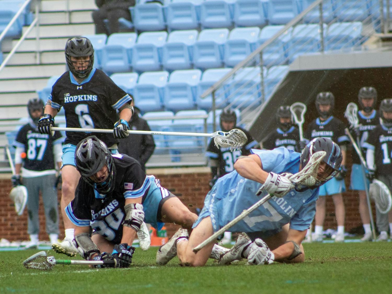 Senior face-off midfielder Zac Tucci (7) fights for possession of the ball in the Feb. 27 men's lacrosse game against Johns Hopkins University. UNC won 15-9.