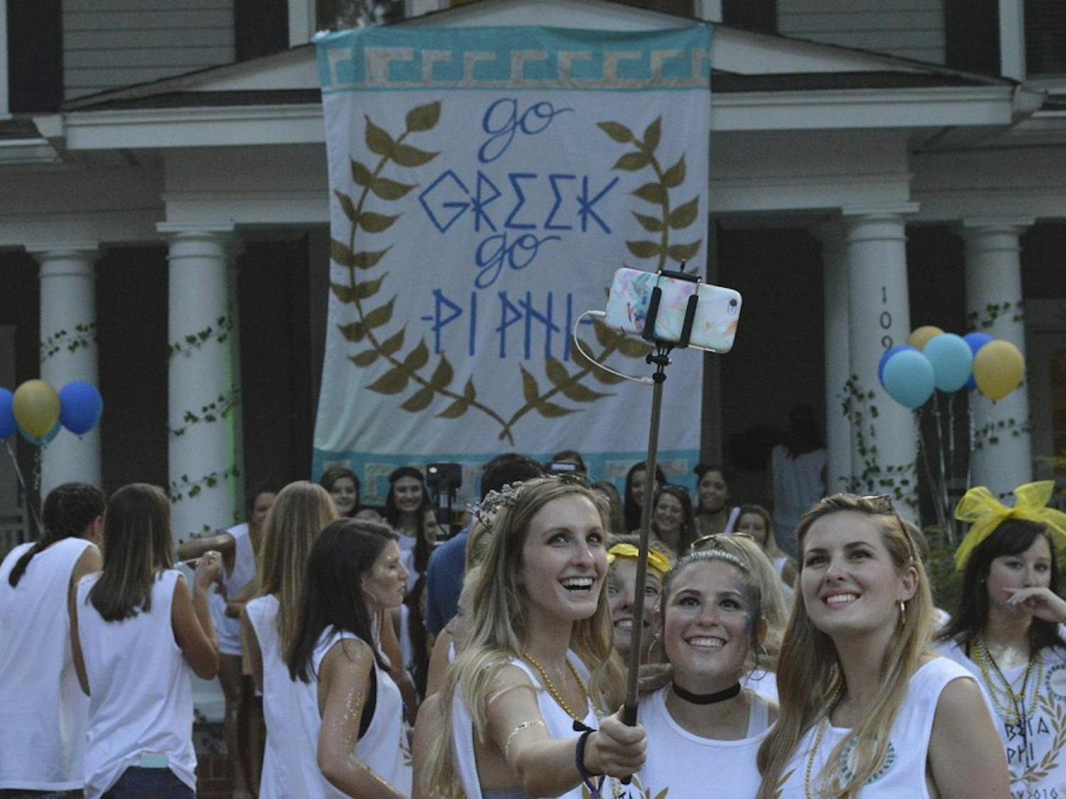 Girls take a selfie outside Pi Beta Phi as they join in their house's Bid Day celebrations.