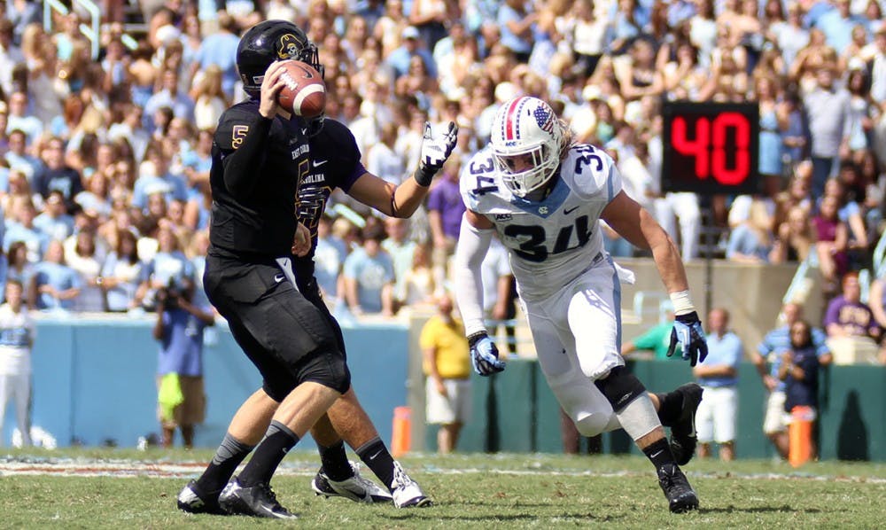 	UNC linebacker Jeff Schoettmer chases down ECU quarterback Shane Carden. The Tar Heels failed to sack Carden in Saturday’s 55-31 loss.