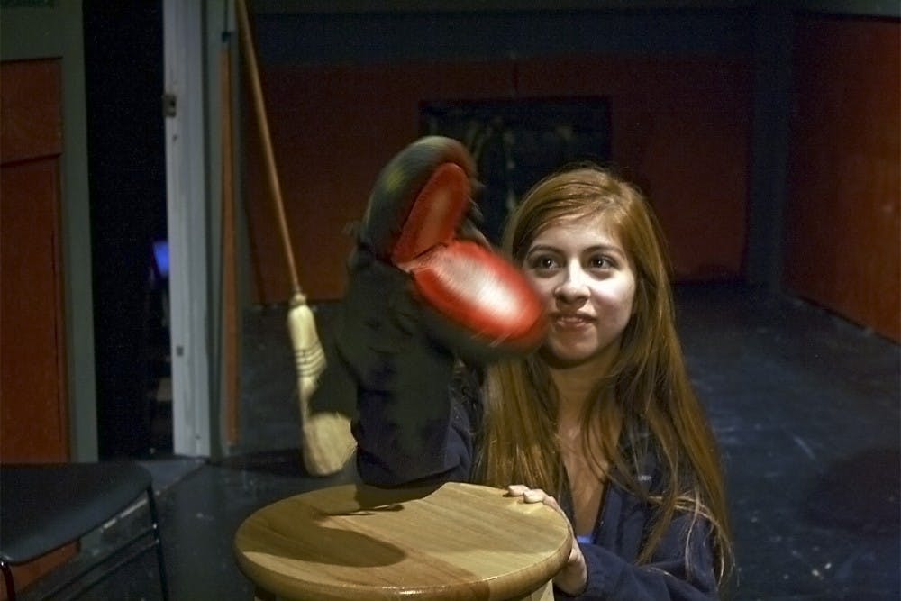 Freshman Stephanie Clinton, who is a puppeteer, practices for the upcoming production, Little Shop of Horrors.