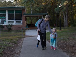 Becca Wright, parent of 2 Glenwood children, Eaden and Elsa leaves with her daughter Mable after school on Tuesday Oct. 30. "I'm just glad the program isn't ending". &nbsp;Wright says as her children run circles around her.&nbsp;