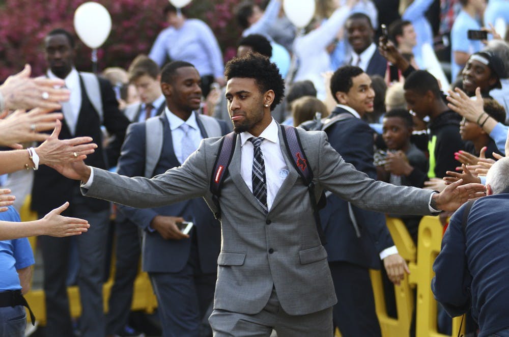 Joel Berry (2) high fives fans on his way to the team’s bus that will take them to Houston. The UNC men’s basketball team will face Syracuse on Saturday.&nbsp;