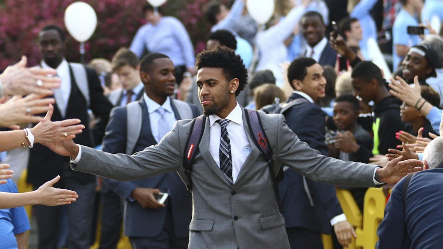 Joel Berry (2) high fives fans on his way to the team’s bus that will take them to Houston. The UNC men’s basketball team will face Syracuse on Saturday.&nbsp;