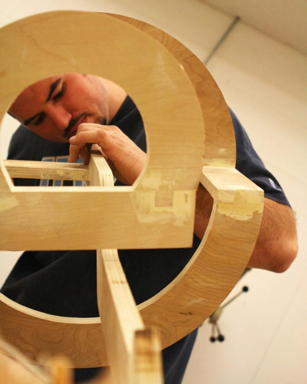 Students work on their wood pieces during class.  The student's assignments was to build a sculpture inspired off a keyboard symbol.