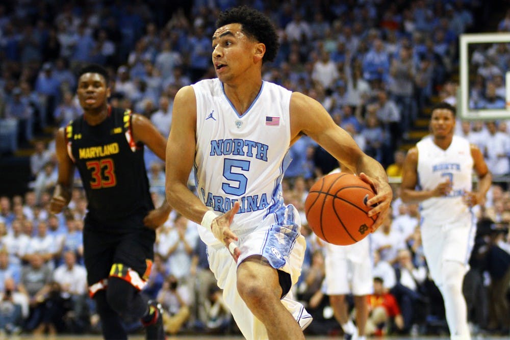 <p>Senior guard Marcus Paige (5) drives the ball towards the basket. This was Paige’s first game back after suffering a fracture to his non-shooting hand.</p>