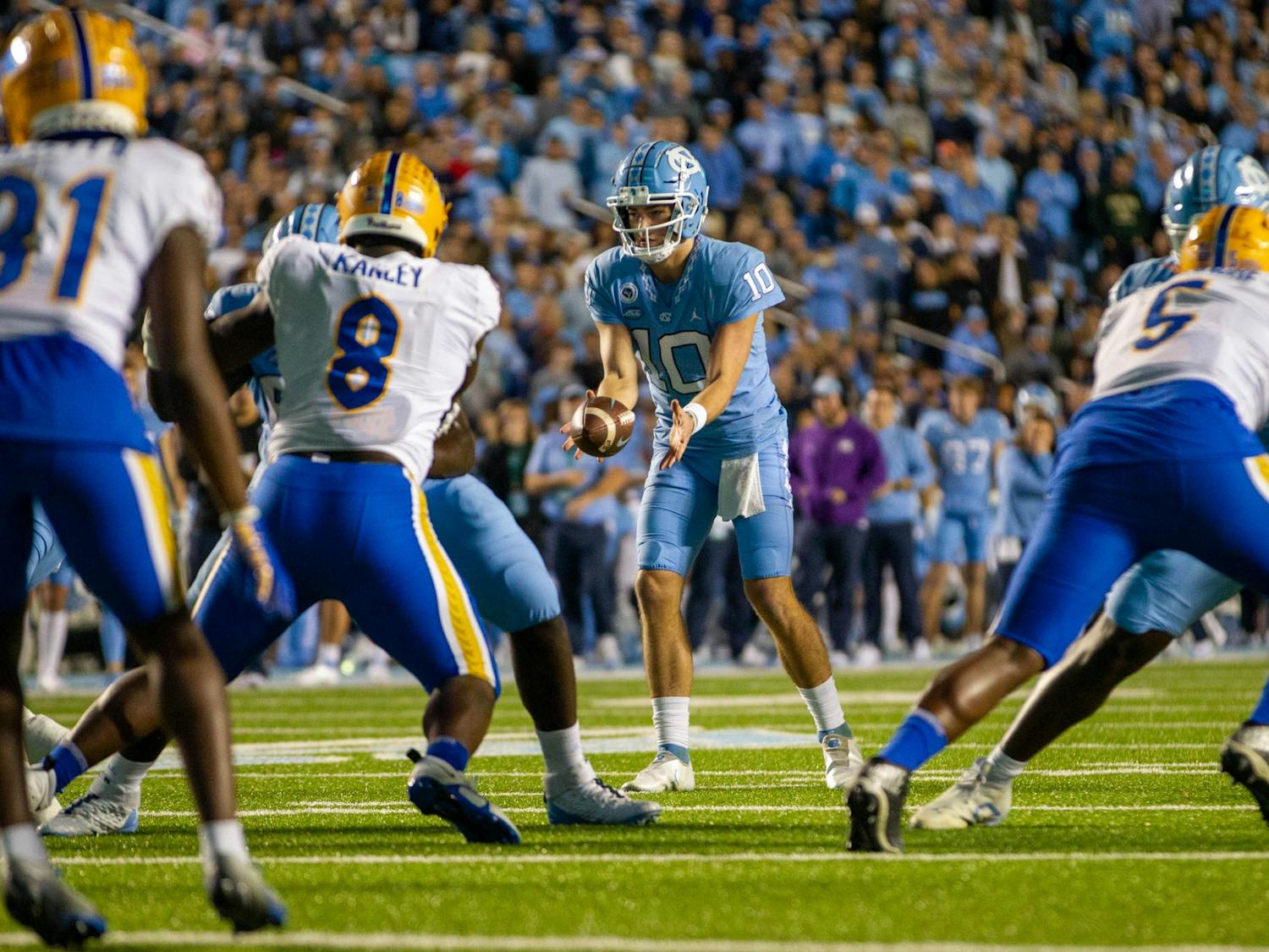 UNC redshirt first-year quarterback Drake Maye (10) catches the snap at the homecoming football game against Pitt on Oct. 19, 2022 at Kenan Stadium. UNC beat Pitt 42-24.