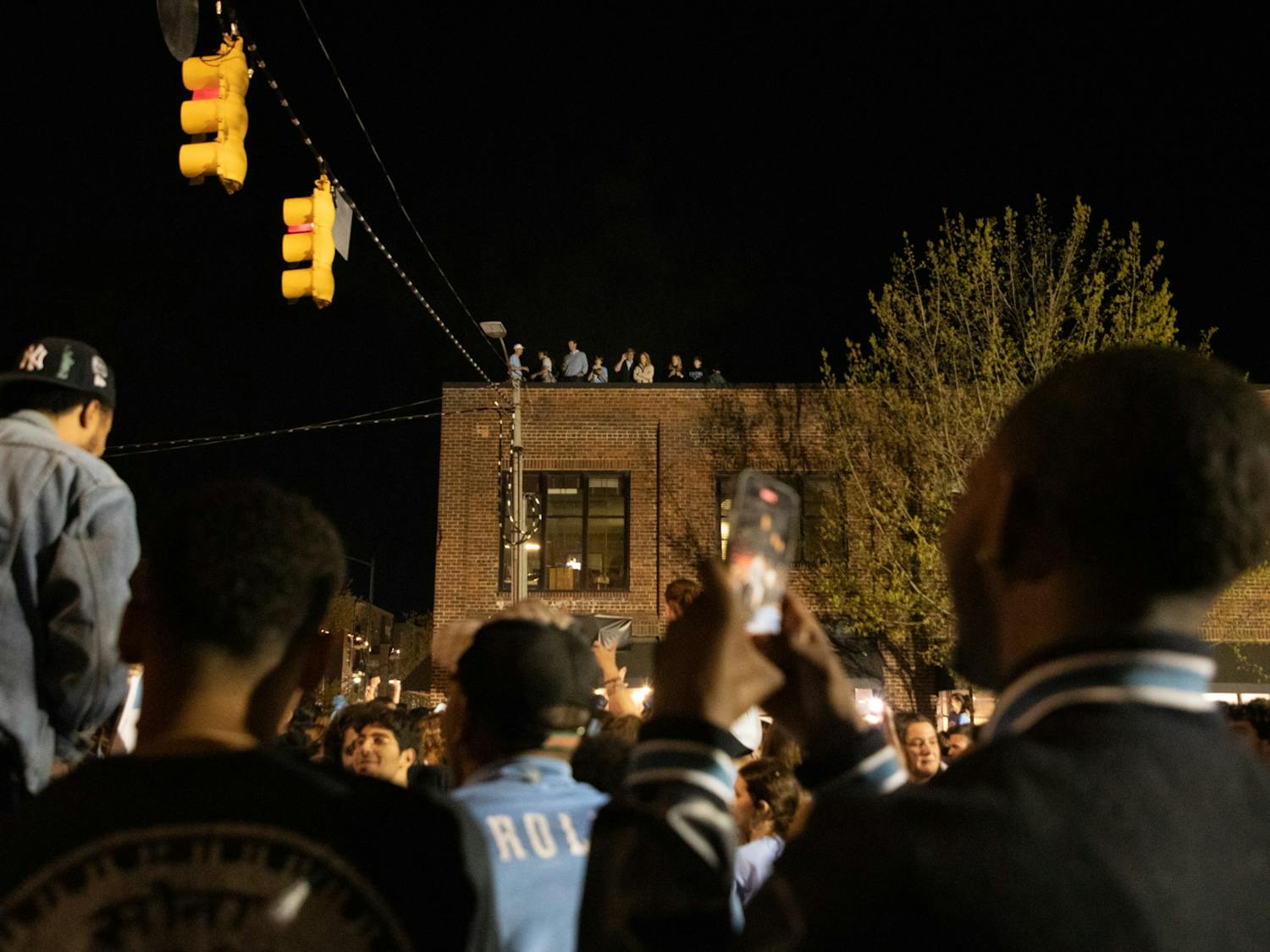 UNC fans rush Franklin St. to celebrate the win over Duke in the Final Four game on Saturday, April 2, 2022.