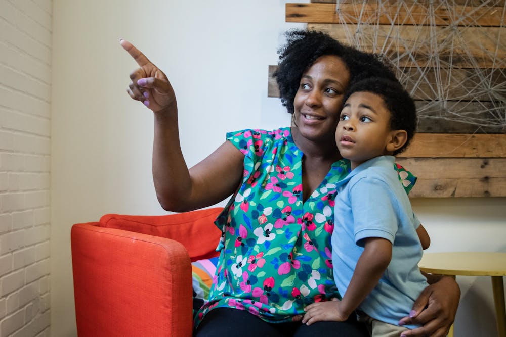 Maya Jackson, the founder of Mobilizing African American Mothers Through Empowerment (MAAME), spends some time with her son August at MAAME's Durham office space.
