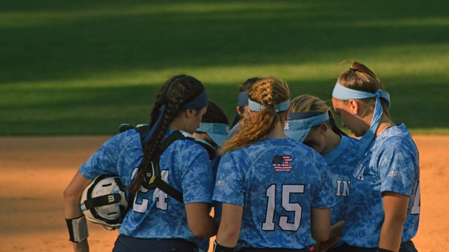 The UNC softball team huddled together to discuss their plays during their game against Louisville Saturday.