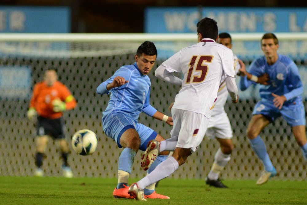 UNC Sophomore Mikey Lopez (5) defends BC Sophomore Diego Medina-Mendez (15) 