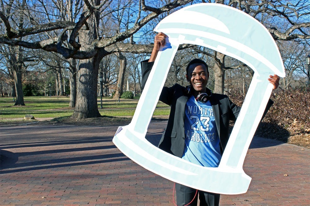 Bradley Opere poses with his Old Well cut out Friday afternoon. Opere held an event to take photographs with people who are supporting his campaign to run for Student Body President. 