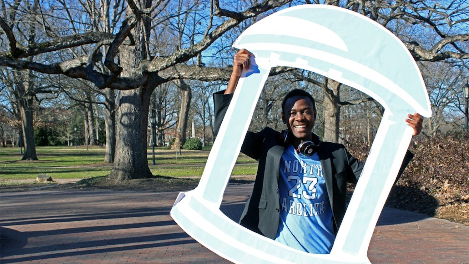 Bradley Opere poses with his Old Well cut out Friday afternoon. Opere held an event to take photographs with people who are supporting his campaign to run for Student Body President. 