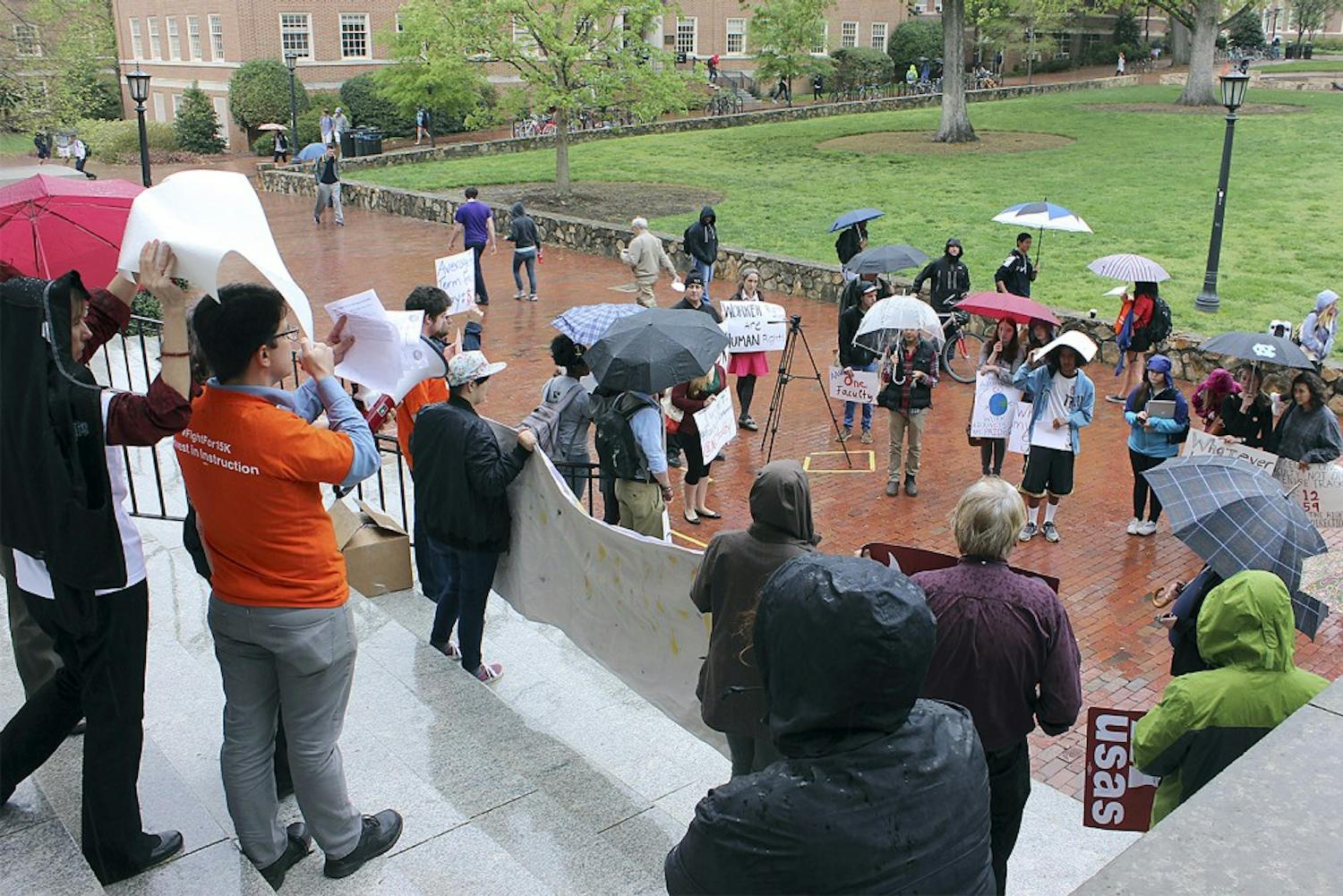 UNC students and faculty gathered in front of Wilson Library Wednesday afternoon to support higher wages for faculty and staff.