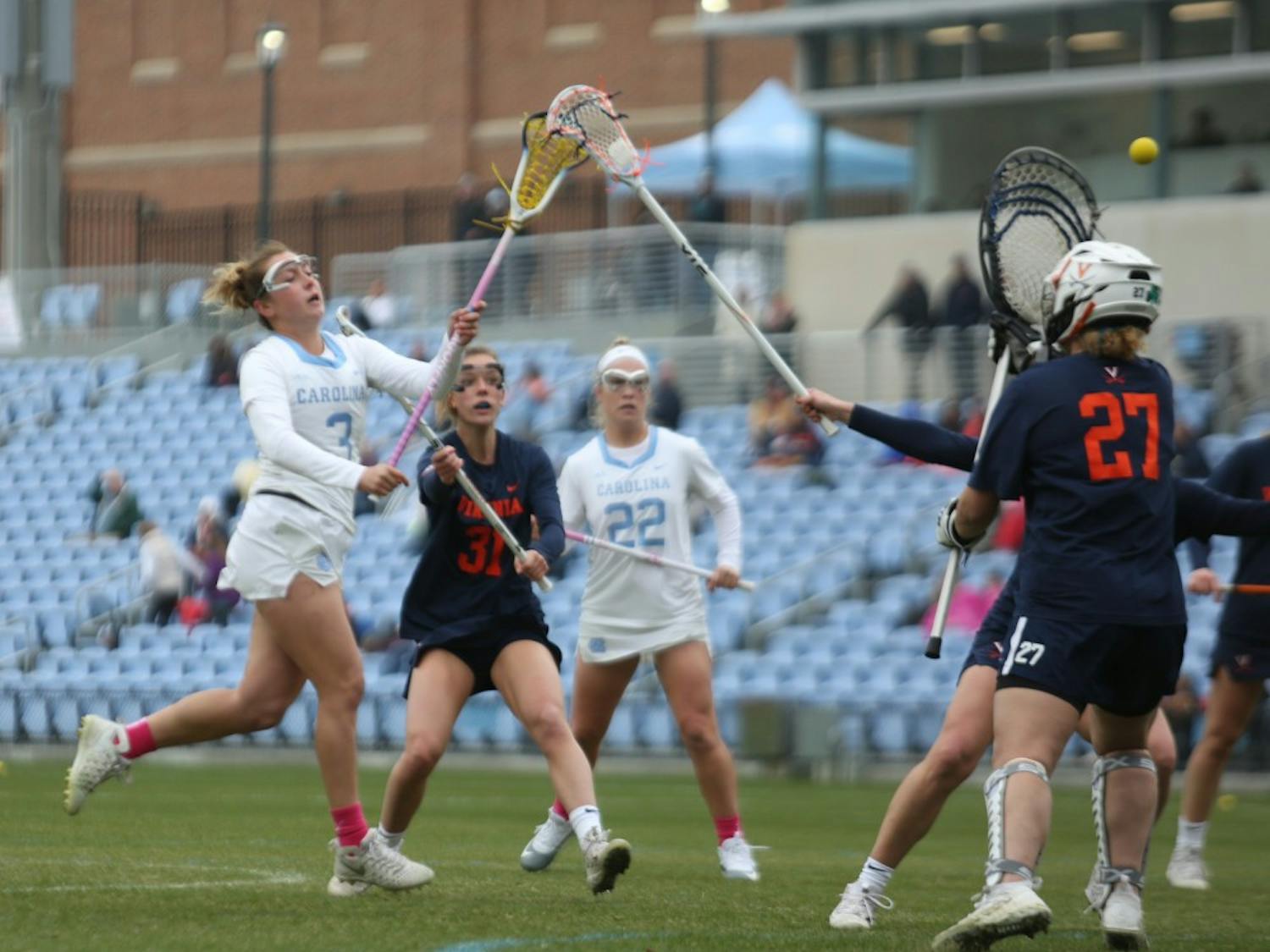 Sophomore attacker Jamie Ortega (3) and first-year attacker Tayler Warehime (22) play during UNC Women's lacrosse first ACC game. UNC defeated UVA 13-12 at Fetzer Field in Chapel Hill on Saturday, March 9, 2019.